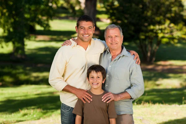Radiant family looking at the camera in the park — Stock Photo, Image