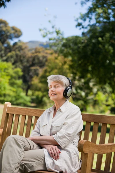 Elderly woman listening to some music — Stock Photo, Image