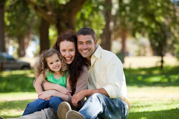 Radiant family sitting in the garden — Stock Photo, Image