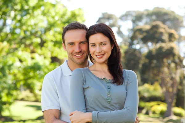 Beautiful couple hugging in the park — Stock Photo, Image