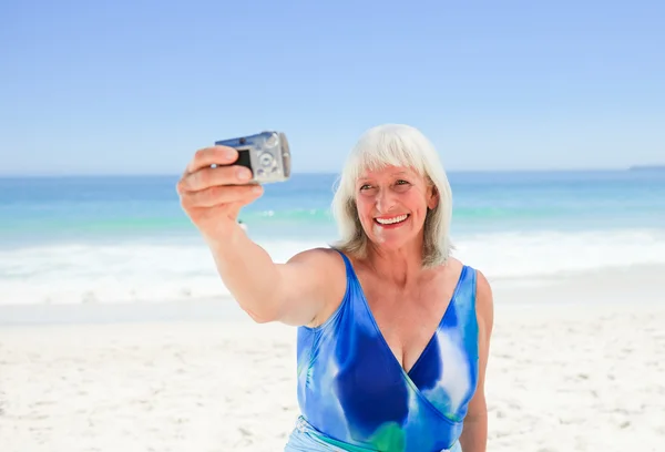 Woman taking a photo of herself — Stock Photo, Image
