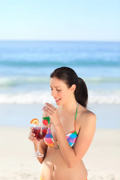Krásná žena pít koktejl na pláži — Stock fotografie