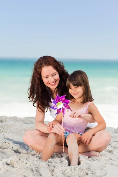 Little girl and her mother with a windmill — Stock Photo, Image