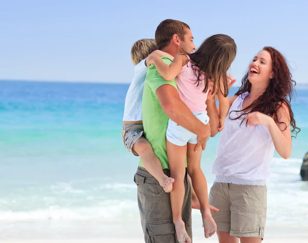 Happy children playing with their parents — Stock Photo, Image