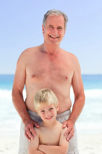 Дід зі своїм онуком на пляжі — стокове фото