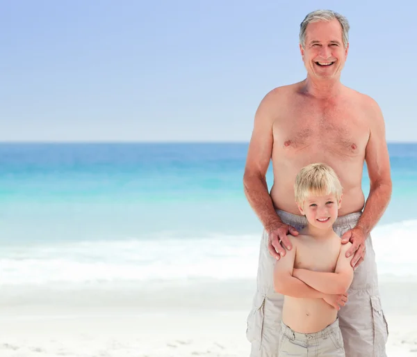 Grandfather with his grandson at the beach — Stock Photo, Image