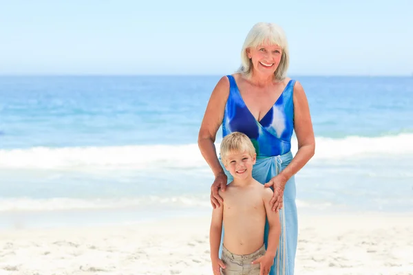Grandmother with her grandson at the beach — Stock Photo, Image