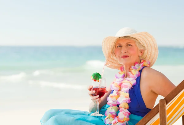 Woman drinking a cocktail in her deck chair — Stock Photo, Image