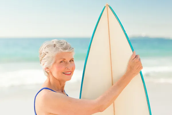 Mulher com sua prancha de surf na praia — Fotografia de Stock