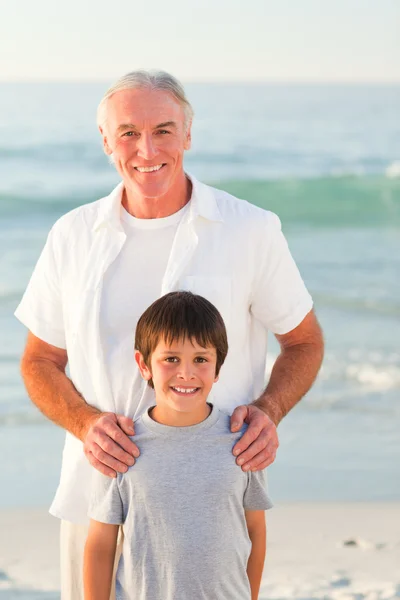 Grandfather and his grandson at the beach — Stock Photo, Image
