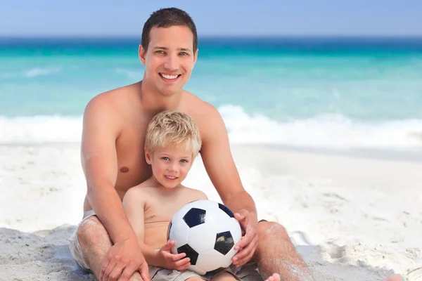 Son playing football with his father — Stock Photo, Image
