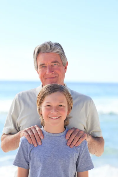 Дедушка с внуком на пляже — стоковое фото