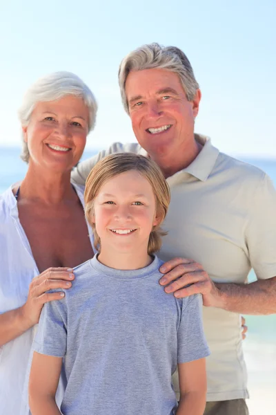 Grand-parents avec leur petit-fils à la plage — Photo