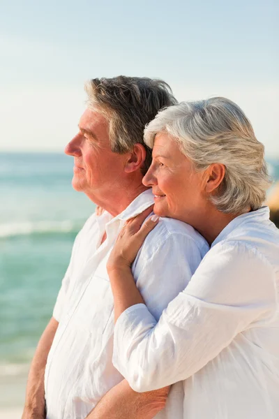 Woman hugging her husband at the beach — Stock Photo, Image