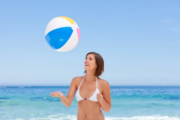 Krásná žena s její míč na pláži — Stock fotografie