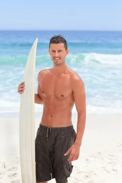 Homem posando com sua prancha de surf — Fotografia de Stock