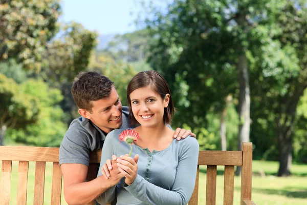 Man and his wife with a flower — Stock Photo, Image