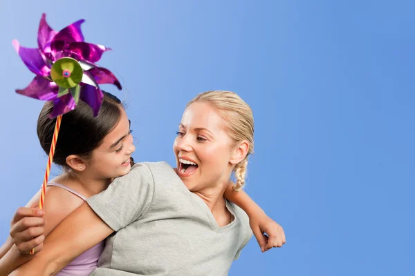 Mother and her daughter with a windmill — Stock Photo, Image