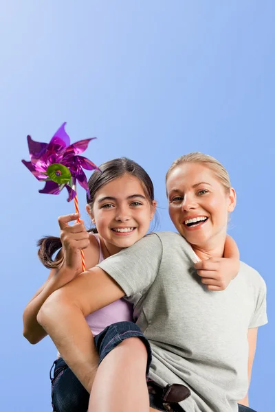 Mother and her daughter with a windmill — Stock Photo, Image