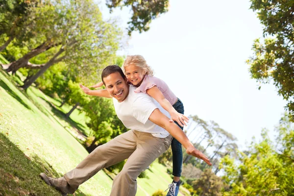 Mała dziewczynka bawiąca się z ojcem w parku — Zdjęcie stockowe