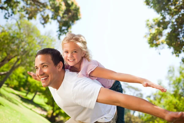 Отец играет со своей дочерью в парке — стоковое фото