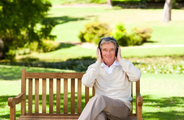 Retired man listening to some music — Stock Photo, Image