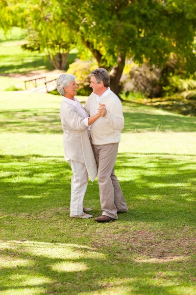 Senior couple dancing in the park — Stock Photo, Image