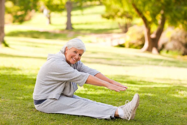 Mujer jubilada haciendo sus estiramientos en el parque — Foto de Stock