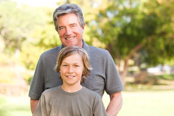 Grandfather with his grandson in the park — Stock Photo, Image