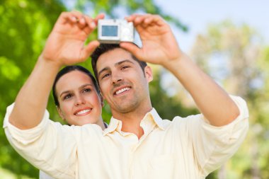 Couple taking a photo of themselve clipart