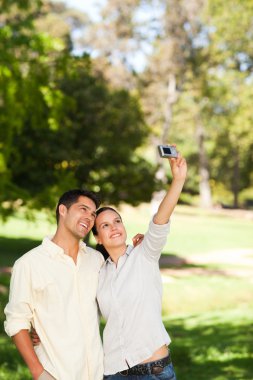 Couple taking a photo of themselve clipart