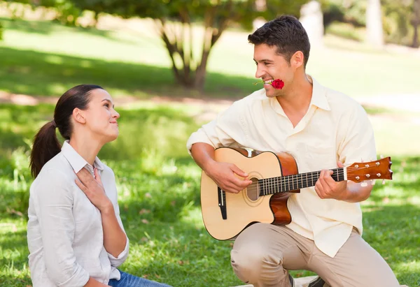 男人为他的女朋友弹吉他 — 图库照片
