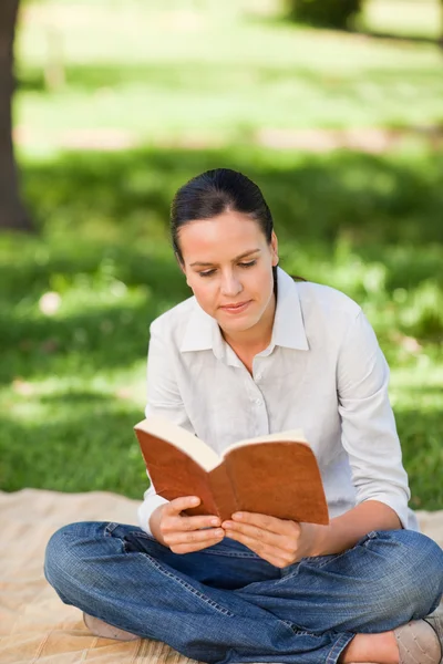Woman reading in the park — Stock Photo, Image