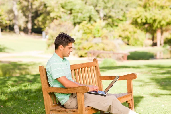 Young man with his laptop — Stock Photo, Image