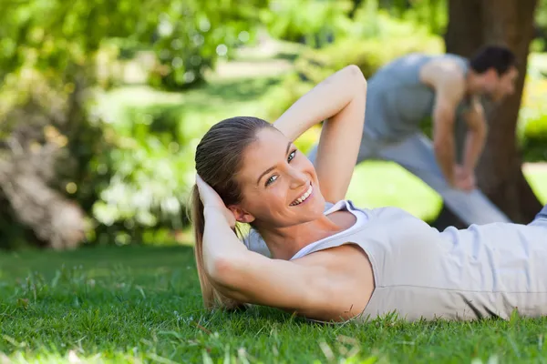 Couple doing their stretches in the park Stock Picture