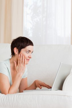 Portrait of a surpised woman using a laptop clipart