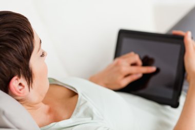 Woman using a tablet computer clipart