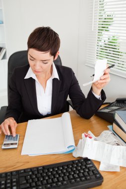 Portrait of an active accountant checking receipts clipart