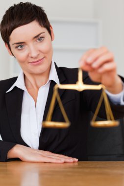 Woman holding the justice scale clipart