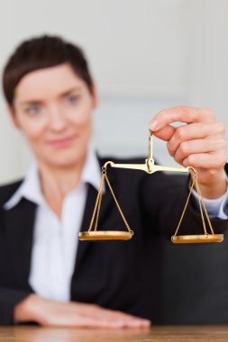 Portrait of a businesswoman holding the justice scale clipart