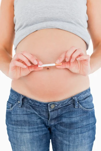Mladá těhotná žena drží cigaretu stoje — Stock fotografie