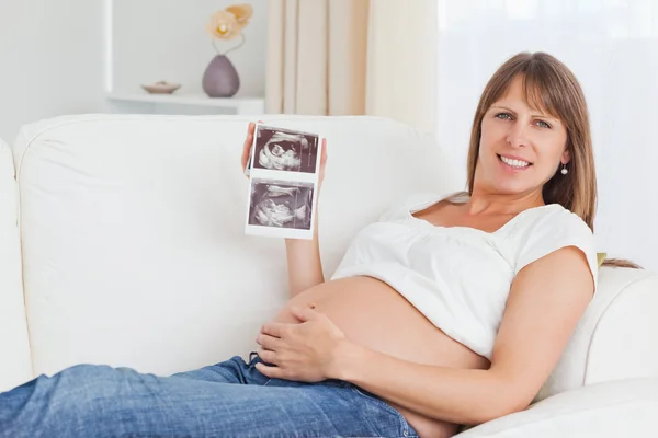 Mulher grávida mostrando ultra-som de seu bebê — Fotografia de Stock