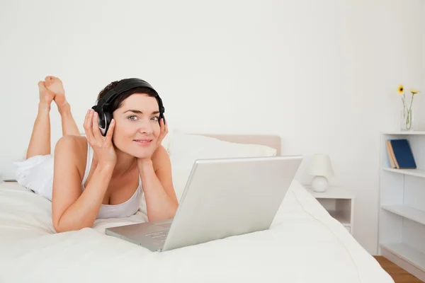Cute woman watching a movie with her laptop — Stock Photo, Image