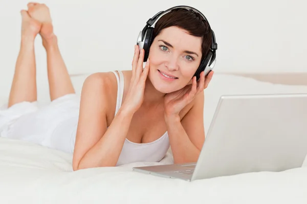 Lovely woman watching a movie with her laptop — Stock Photo, Image
