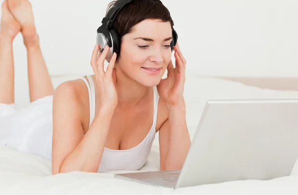 Close up of a cute woman watching a movie with her laptop — Stock Photo, Image