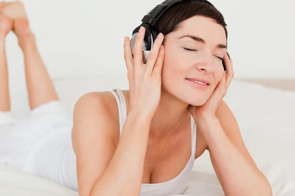 Close up of a brunette listening to music — Stock Photo, Image