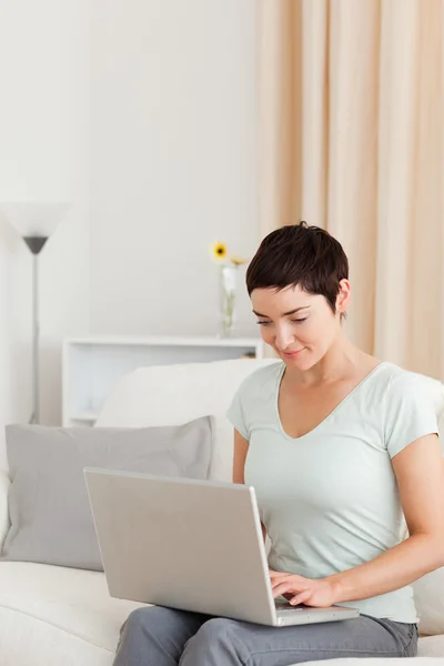 Portrait of a young woman working with a laptop — Stock Photo, Image