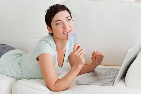 Pensive woman buying online — Stock Photo, Image