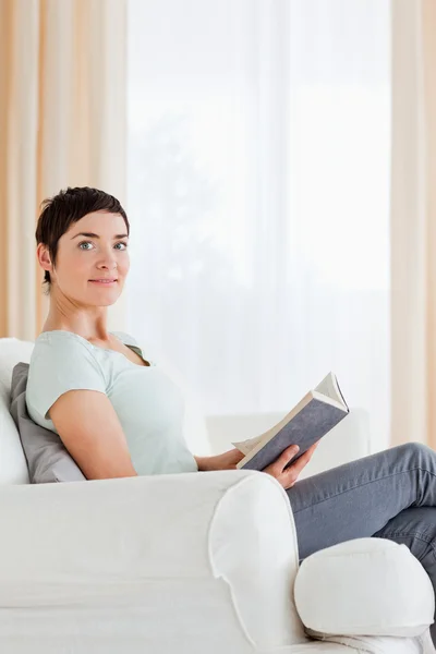 Portrait of a short-haired woman holding a book — Stock Photo, Image