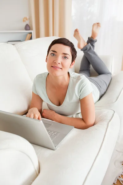 Portrait of a dark-haired woman with a laptop — Stock Photo, Image